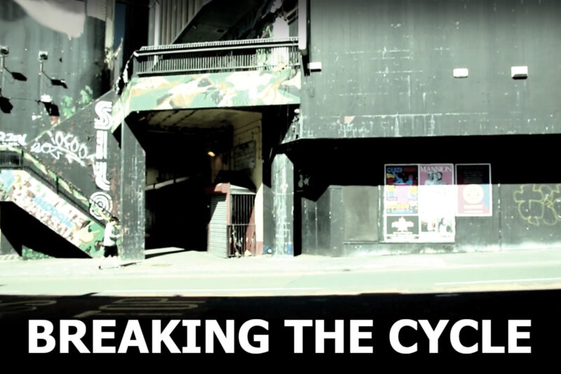 Image of a building in a back alley of central Liverpool with the caption "Breaking the cycle" in capital letters